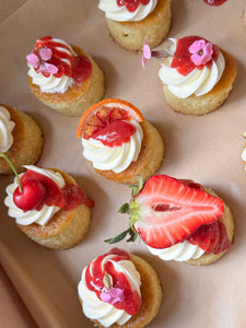 Mini cakes topped with fruit and florals