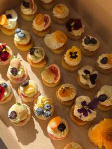 Mini cakes topped with fruit and florals