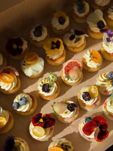 Mini cakes topped with fruit and florals